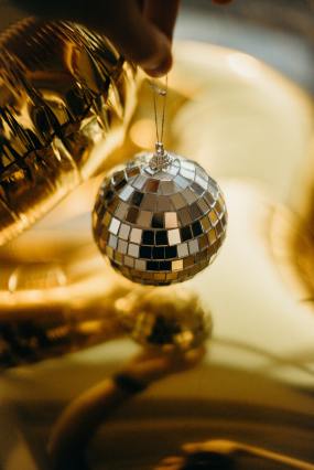 shallow-focus-photo-of-person-holding-gold-disco-ball-3402027