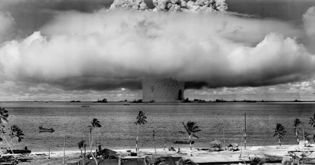 grayscale-photo-of-explosion-on-the-beach-73909